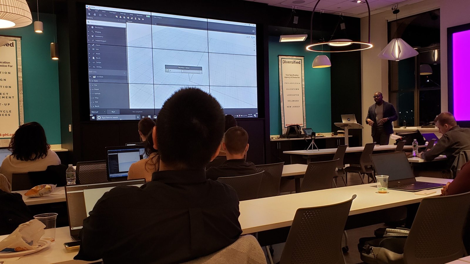 Man standing a podium giving a seminar on Dynamo.